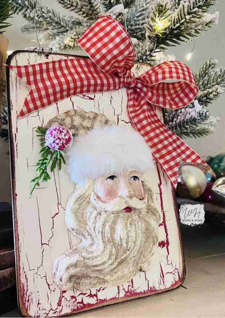 Santa ornament attached to Dollar Tree cutting board with bow