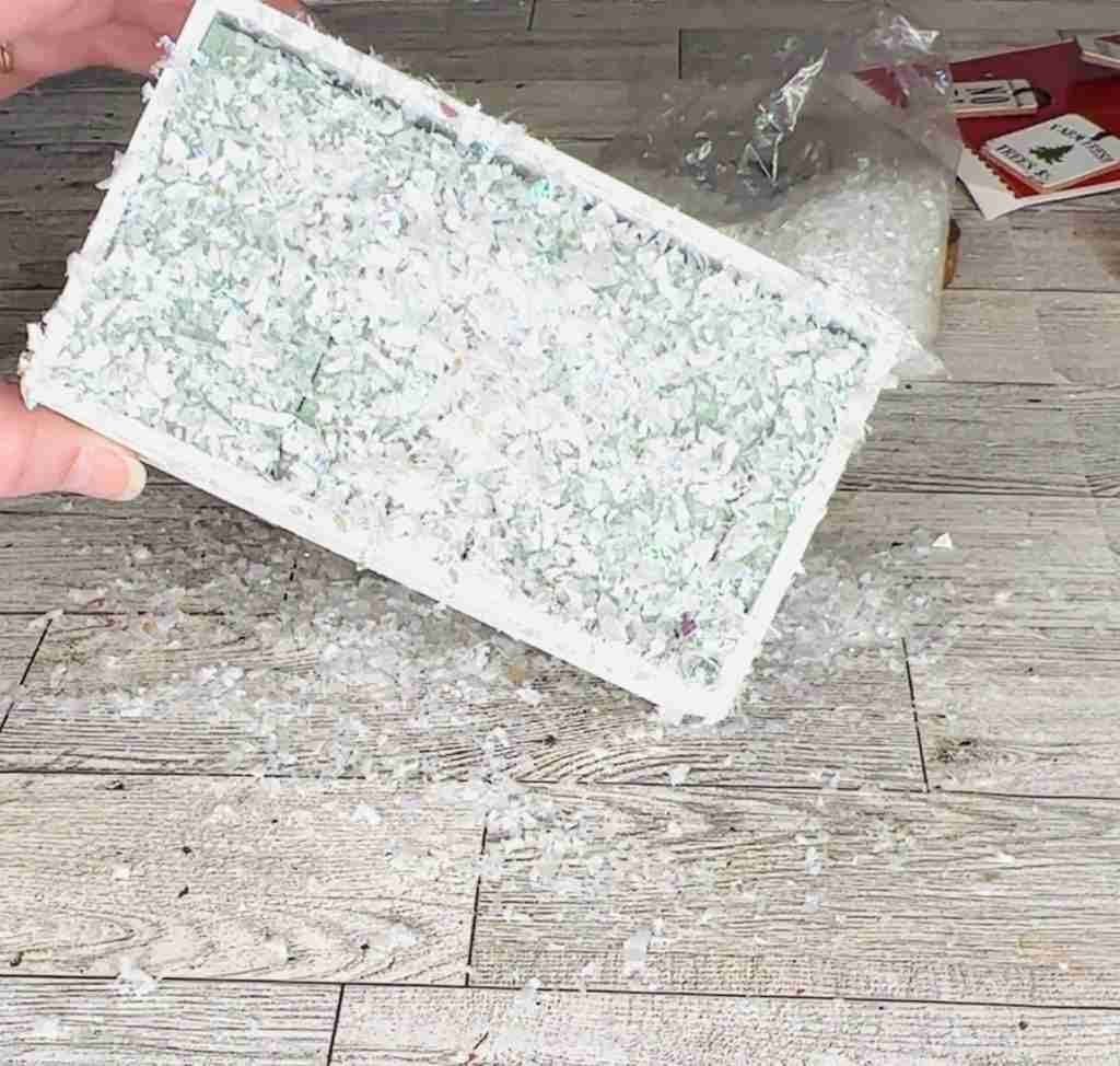 floral foam block inside crate with glue brushed on and snow added
