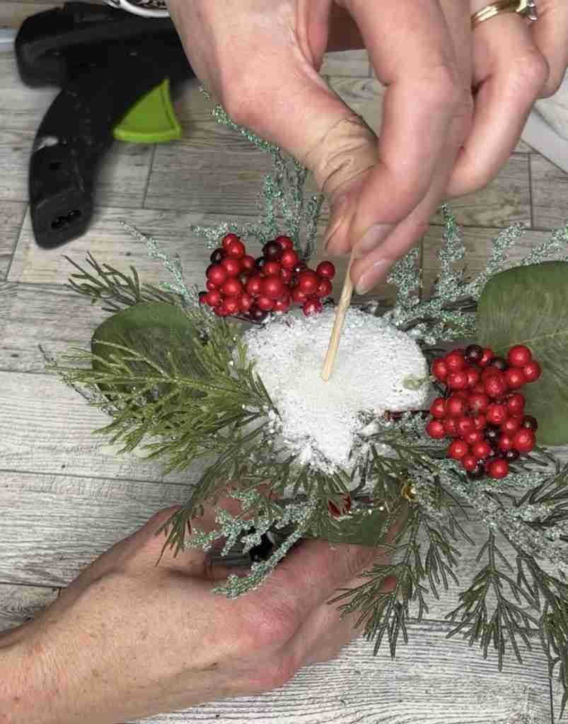 wood skewer inserted into foam to attach snowman ornament