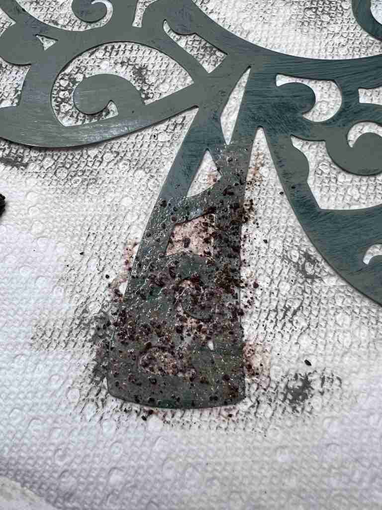 rusting mixture of coffee, sugar, and cinnamon applied to metal shamrock