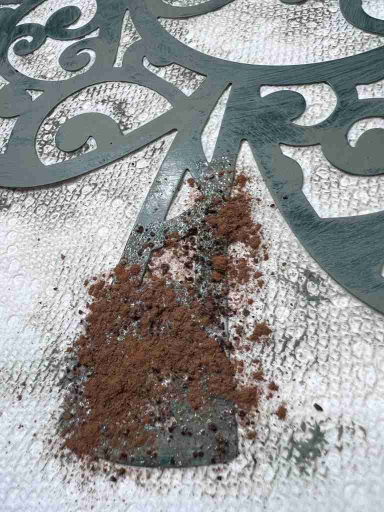 rusting mixture of coffee, sugar, and cinnamon applied to metal shamrock