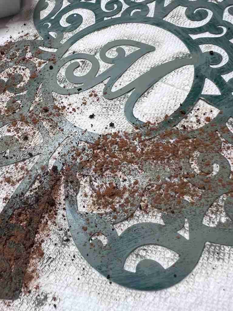 rusting mixture of coffee, sugar, and cinnamon applied to metal shamrock