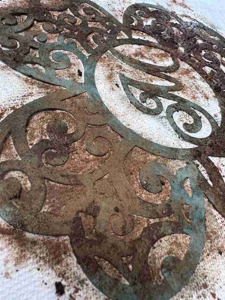 rusting mixture of coffee, sugar, and cinnamon applied to metal shamrock