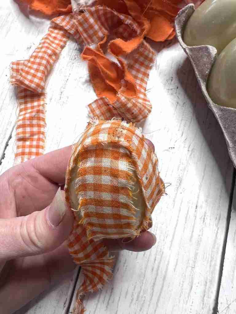 plastic egg covered with material strips
