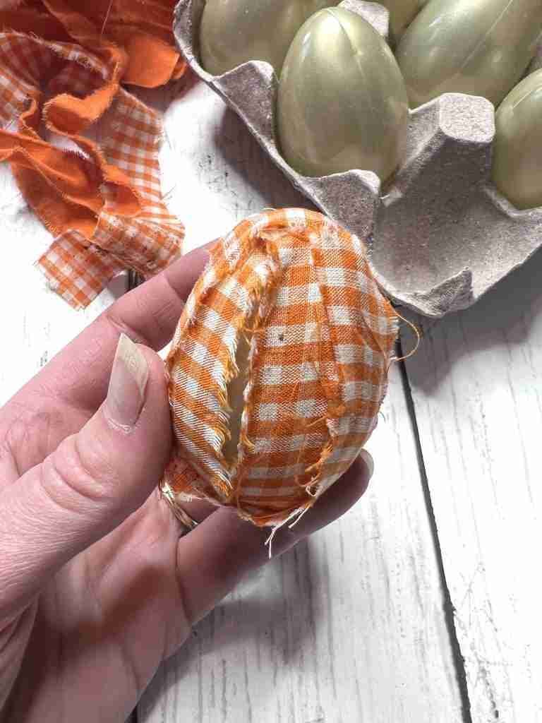 plastic egg covered with material strips