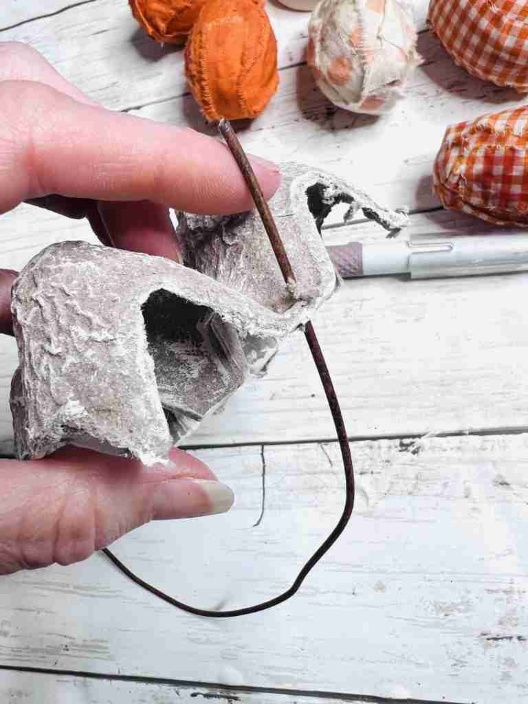 wire inserted into side of egg carton