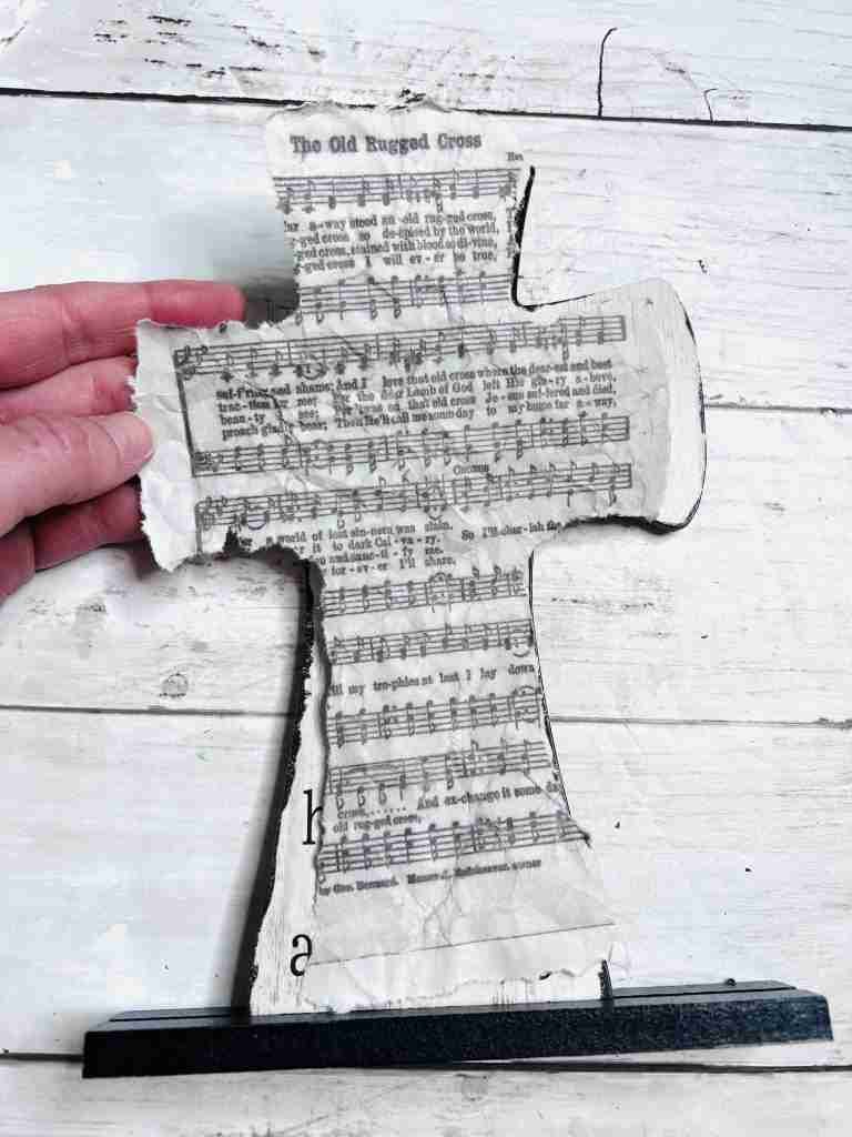 copy of hymn torn to fit cross