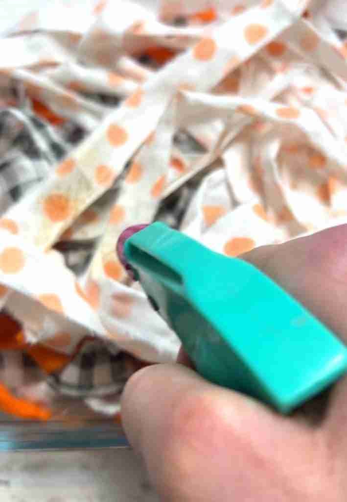 torn material strips sprayed with coffee and vanilla