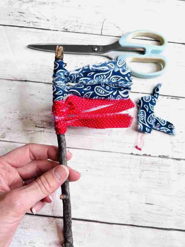 attaching material strips to stick using slip knot