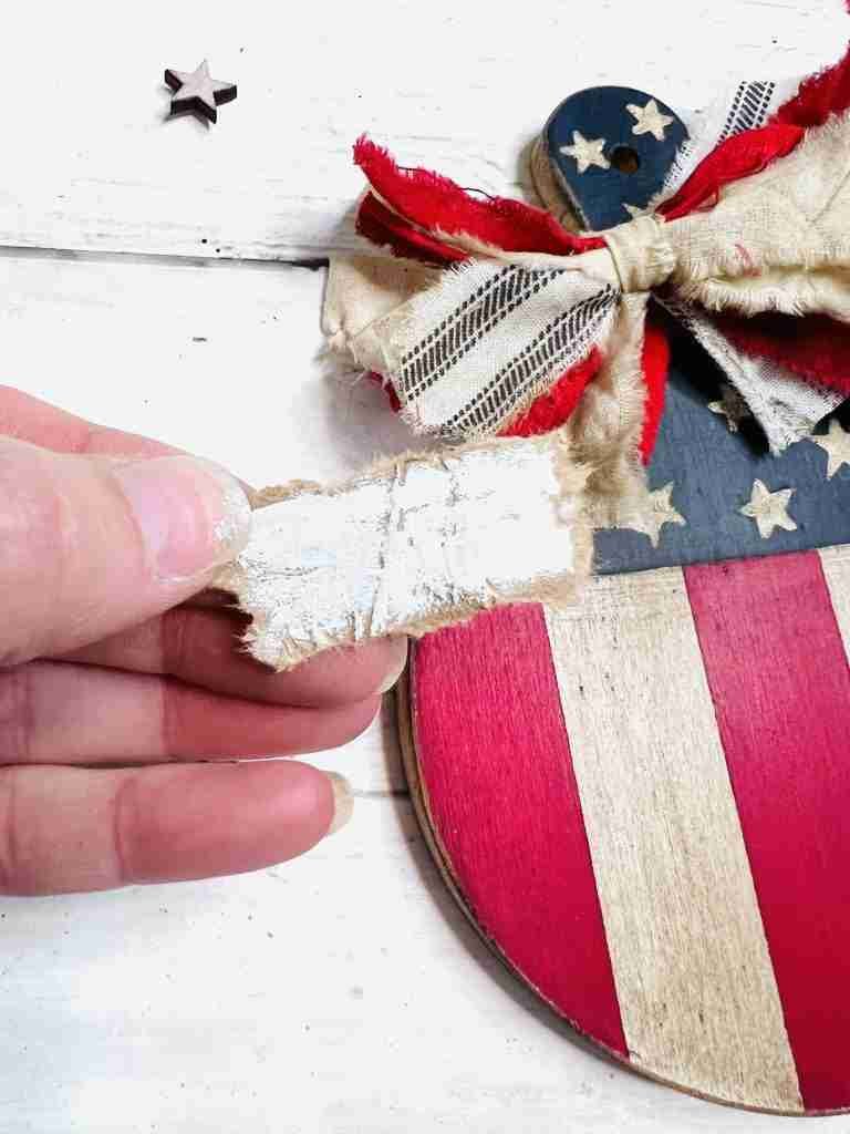 kraft paper rectangle torn with white paint applied