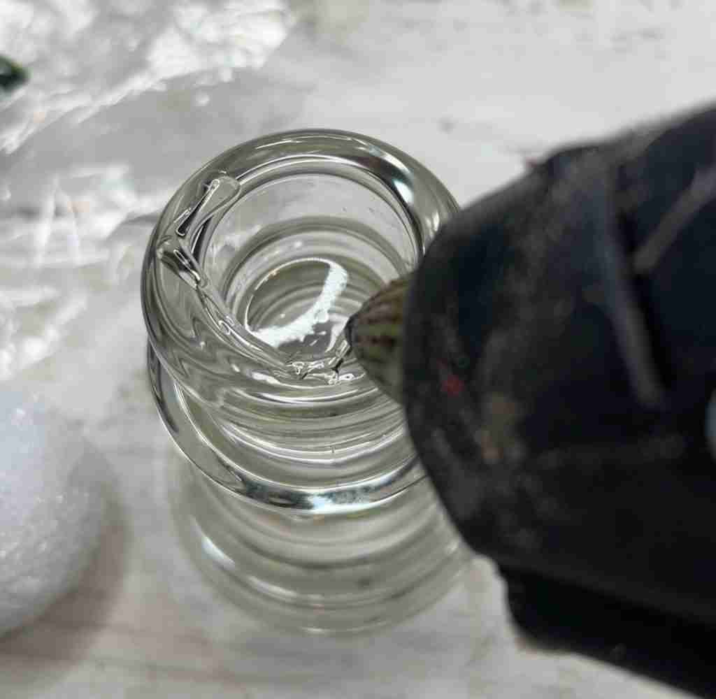 adding hot glue to top of candlestick