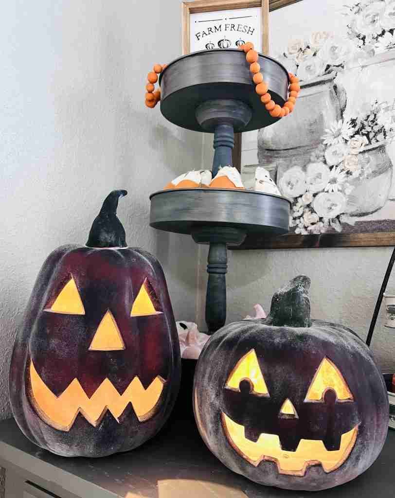 pumpkins with black spray paint and baking soda sprinkled on