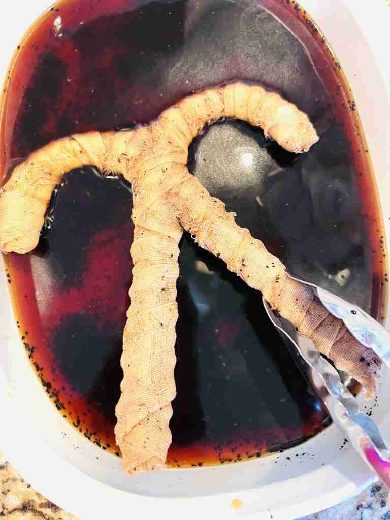 soaking material wrapped candy canes in coffee