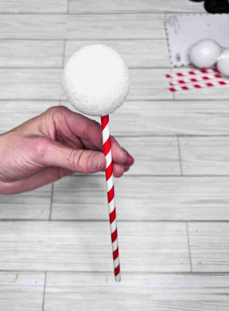 straw inserted into styrofoam ball