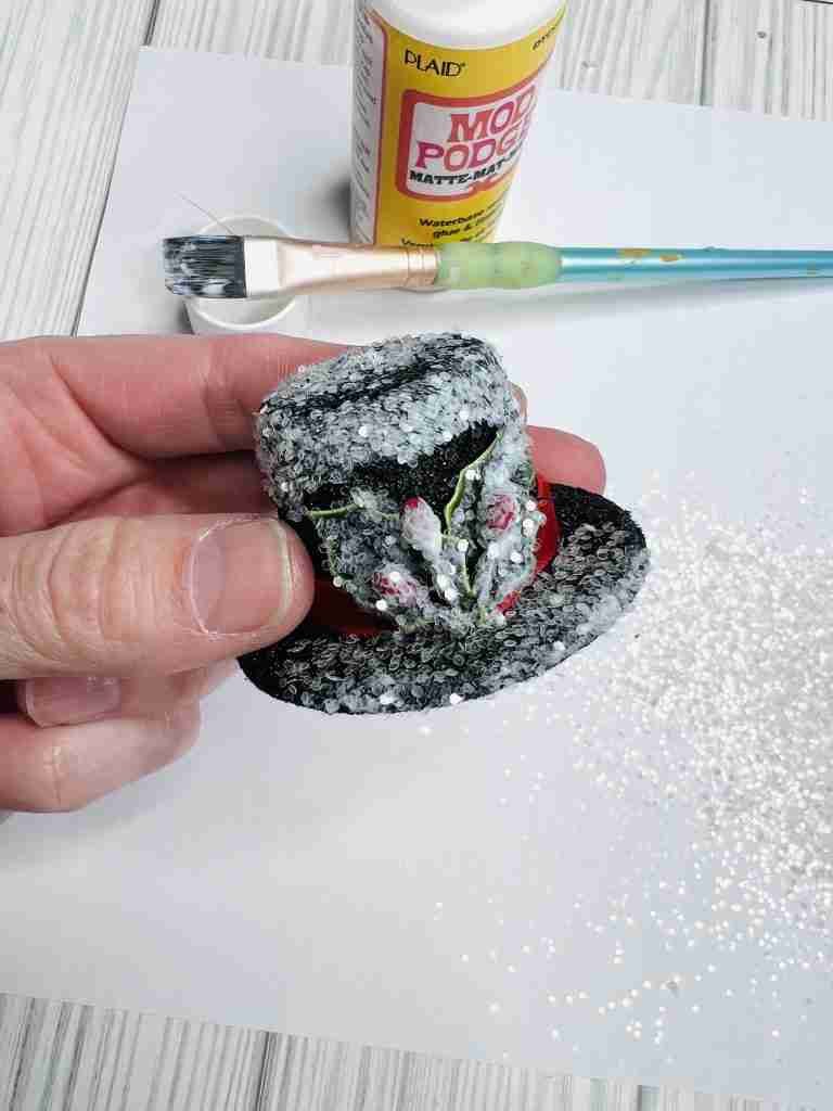 mini hat with Mod Podge and glitter sprinkled on