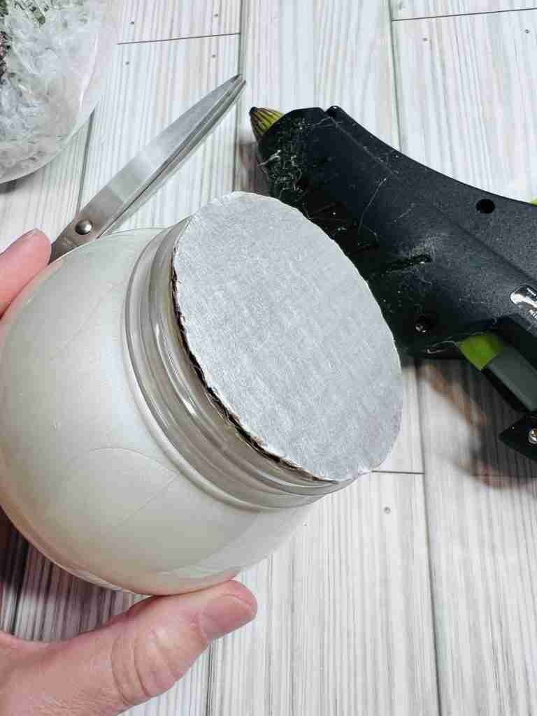 cardboard circle attached to top of plastic globe