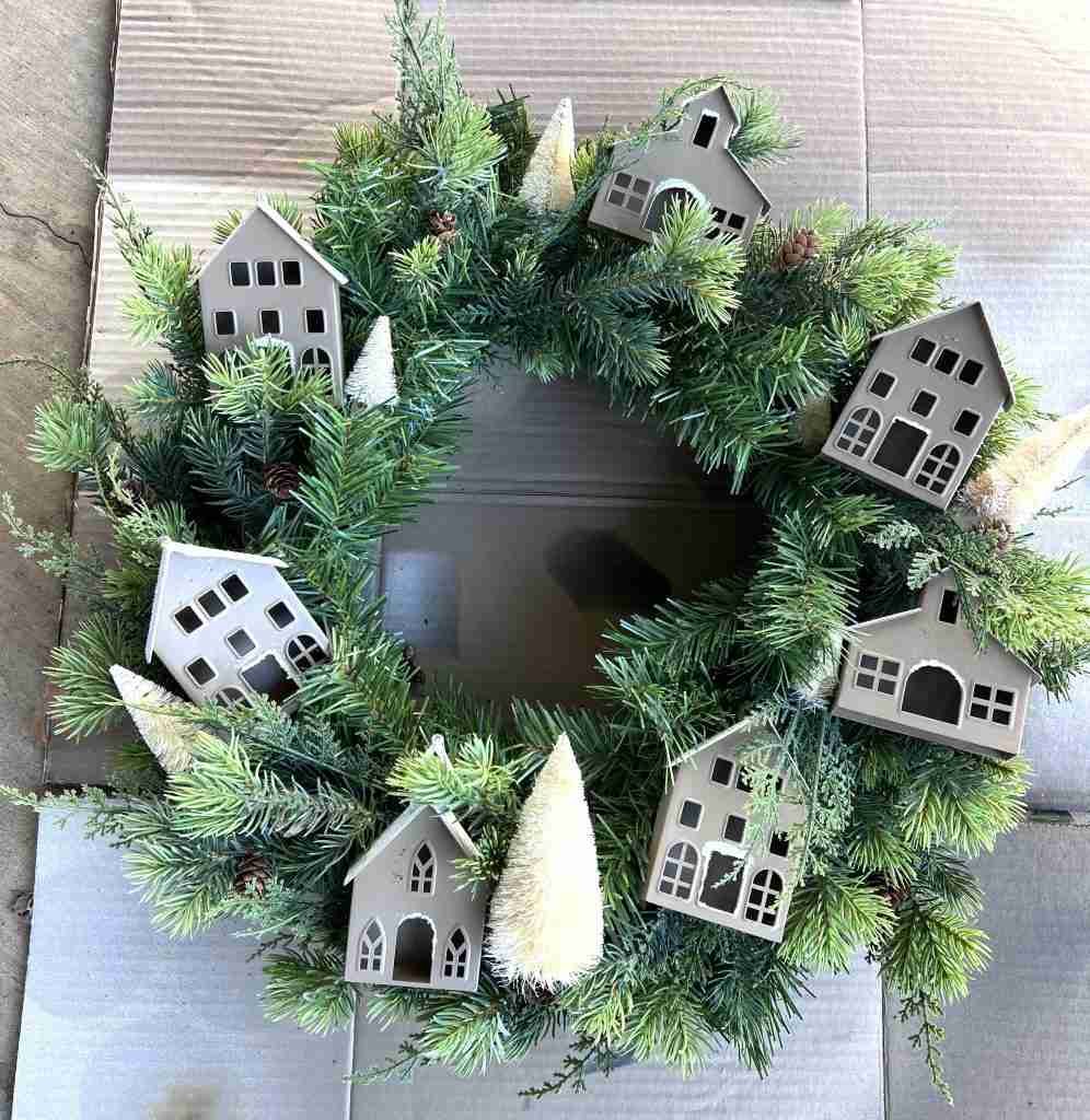 wreath with houses and bottle brush trees attached