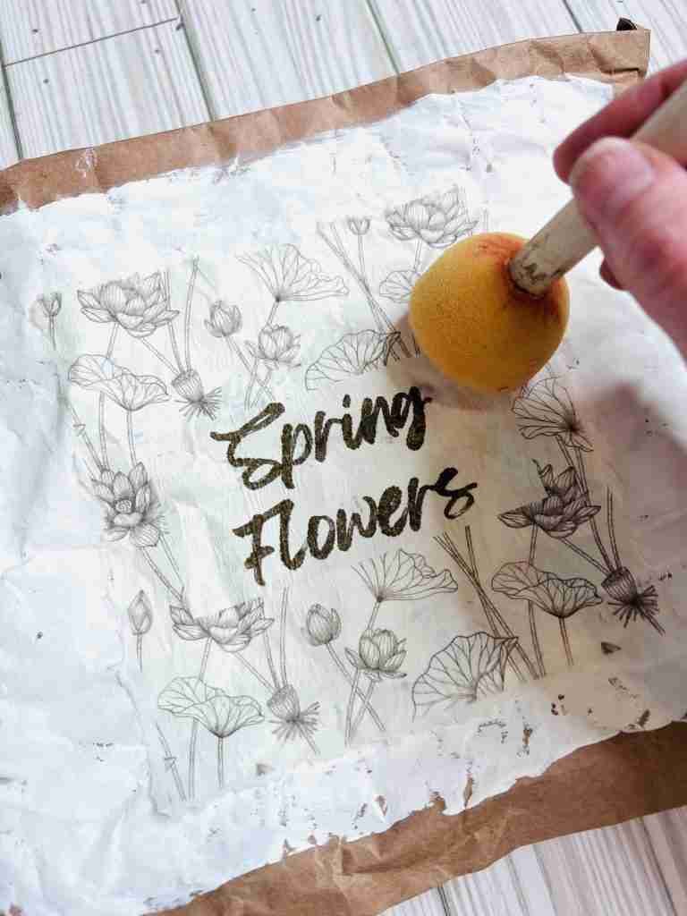 adding the spring flowers printable to front of mailer with Mod Podge