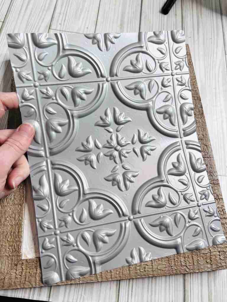 Dollar Tree self adhesive tile cut down to fit frame