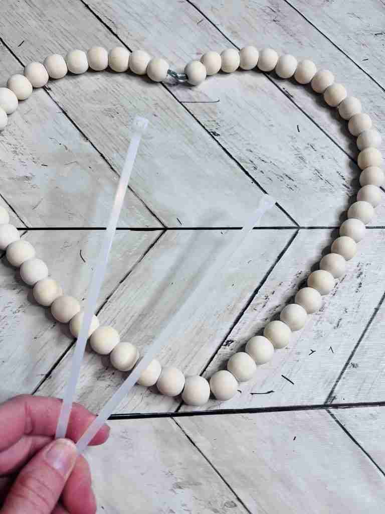 Dollar Tree beaded heart wreath and two zip ties