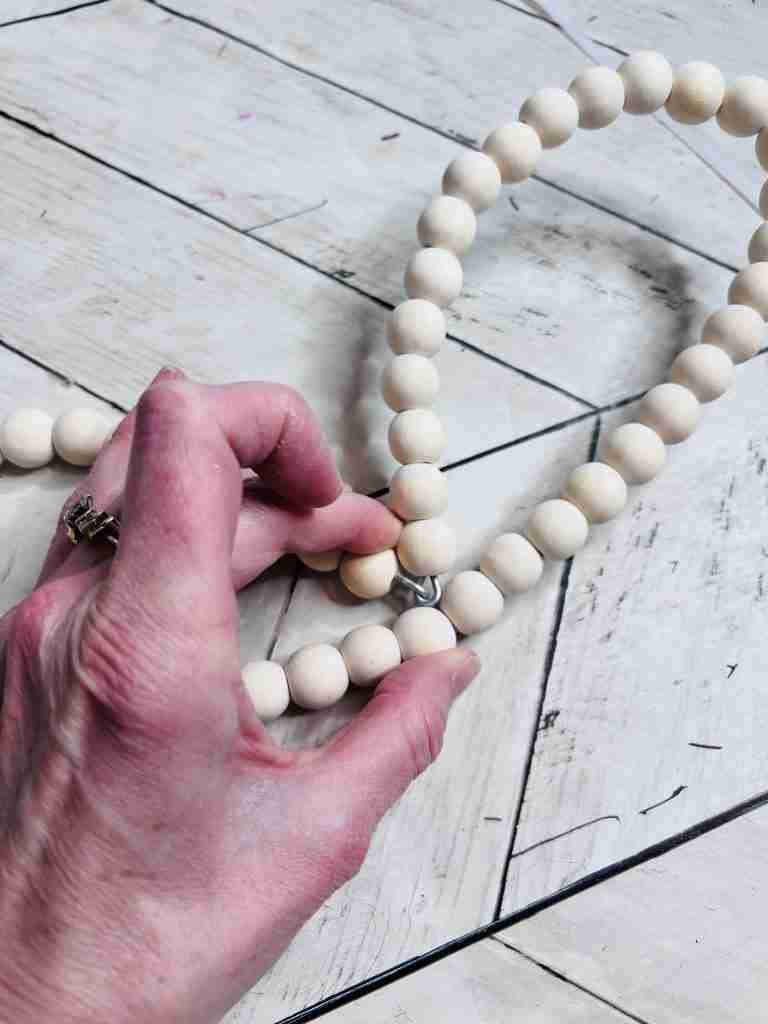 beaded heart wreath with top middle pulled down to bottom