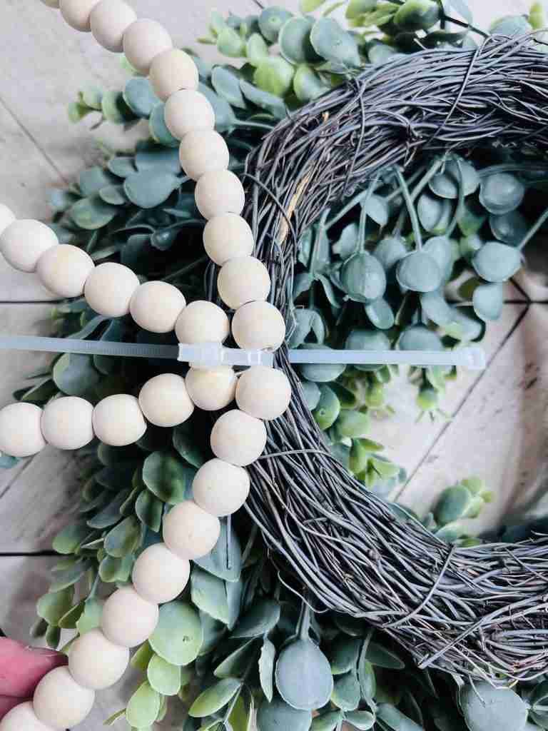 zip tie pushed through top of wreath