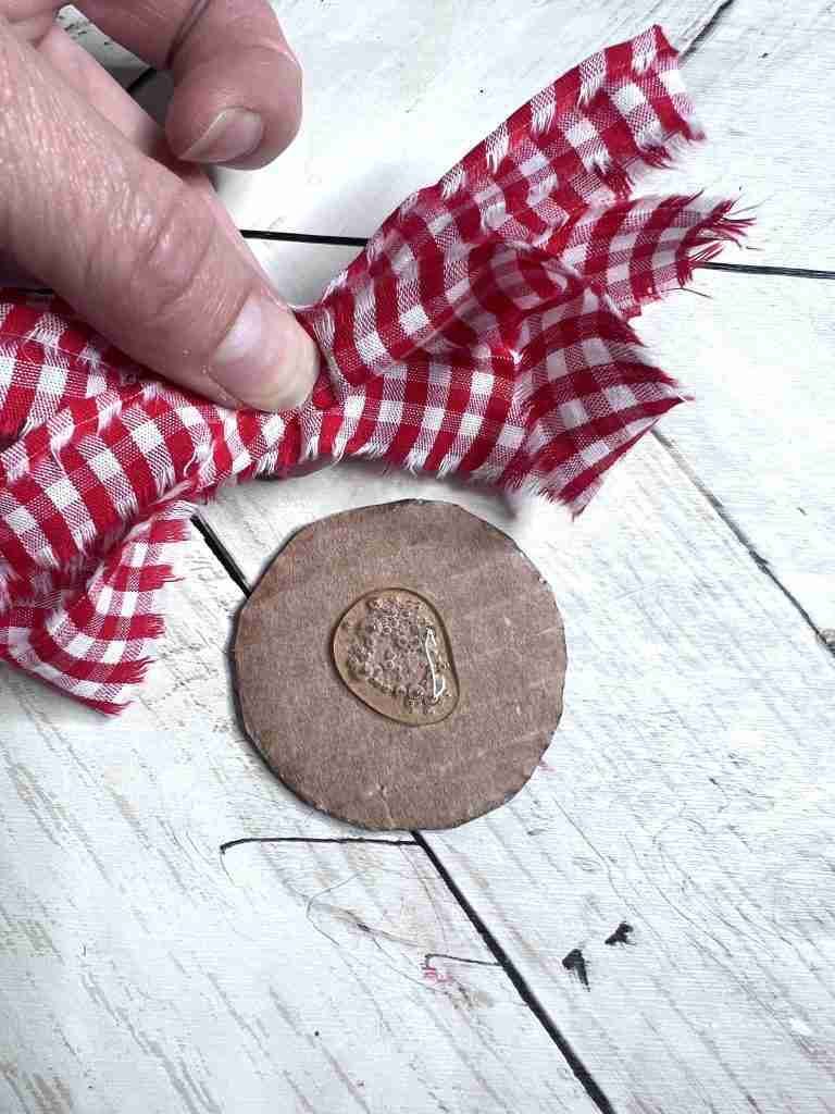 material strip glued onto cardboard circle