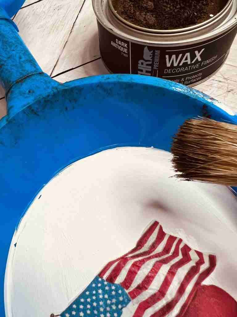 dark Behr wax applied to plastic shovel