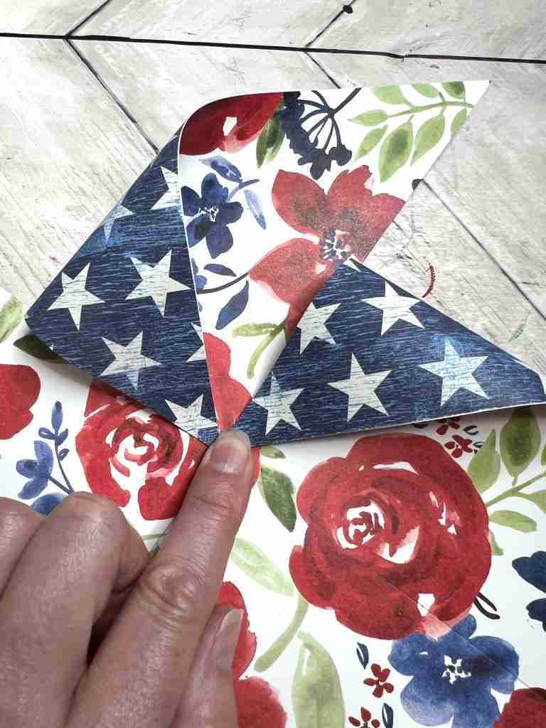 pulling every other cut section down and gluing to the center of the pinwheel