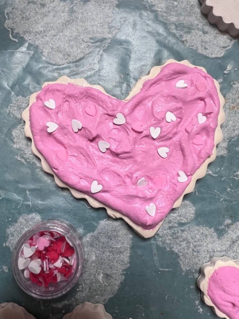 faux spackling icing on clay cookies with faux sprinkles added