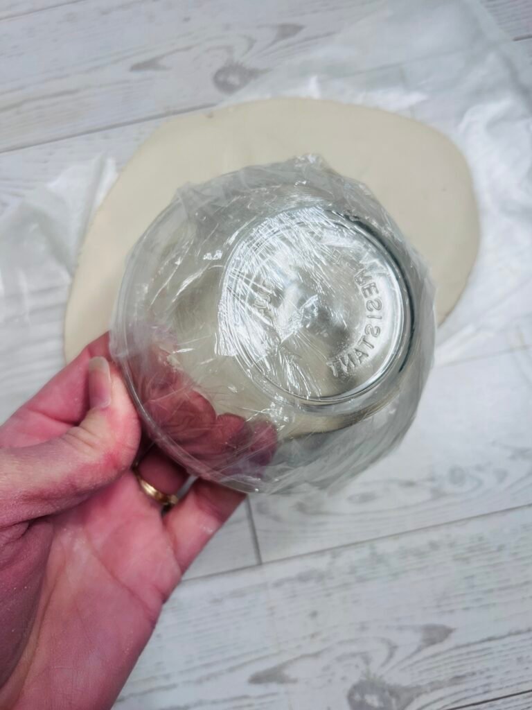 glass bowl covered with plastic wrap