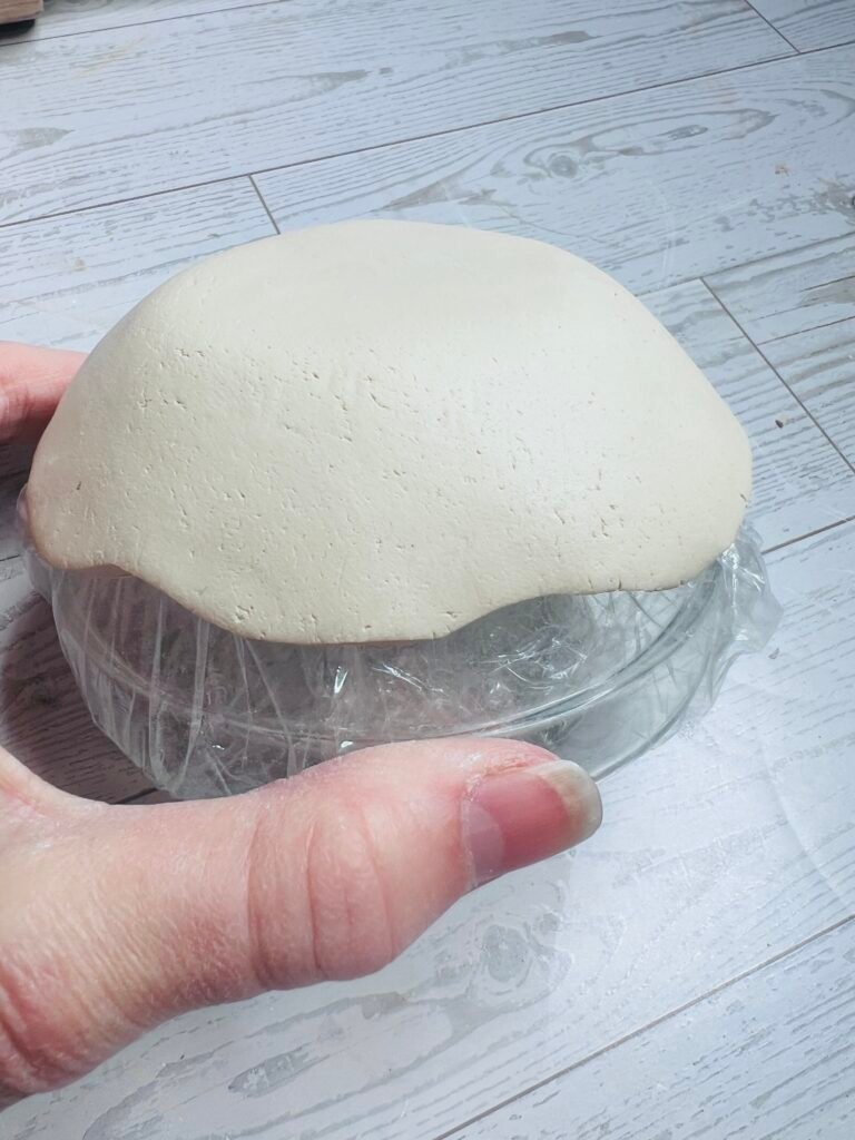 clay pressed onto bottom of glass bowl