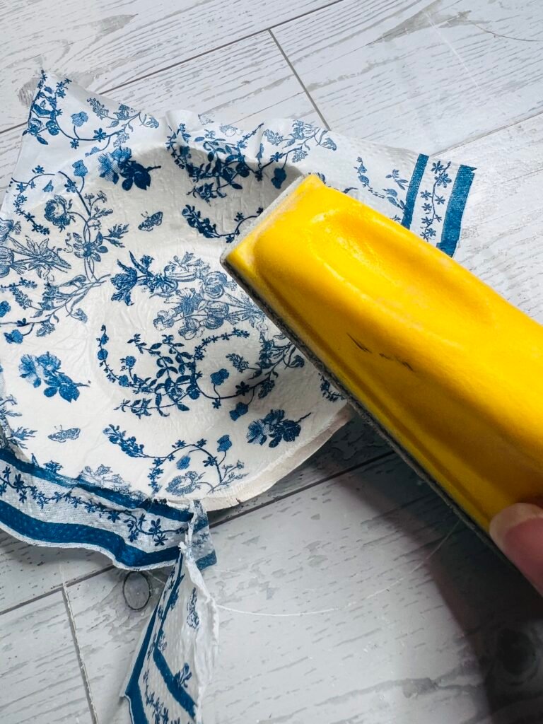 removing excess napkin with sanding block