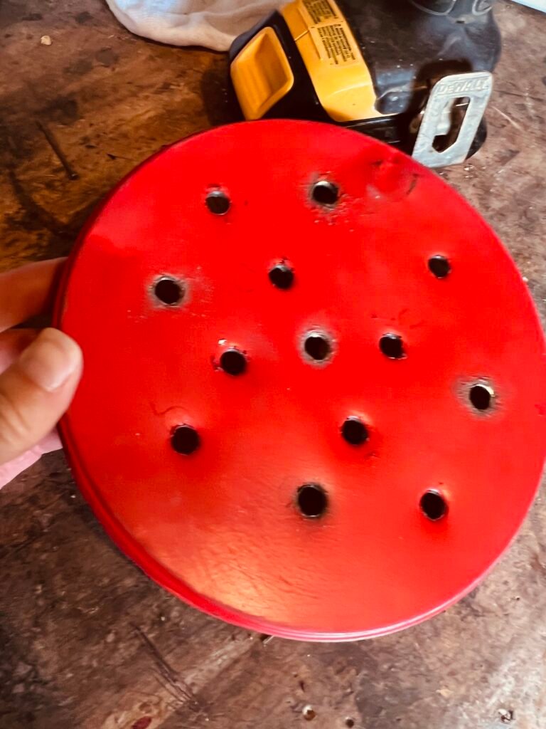 holed drilled in the top of tin can lid