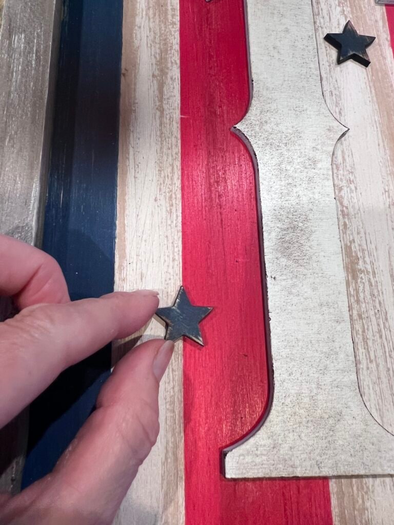 wood stars glued to sign