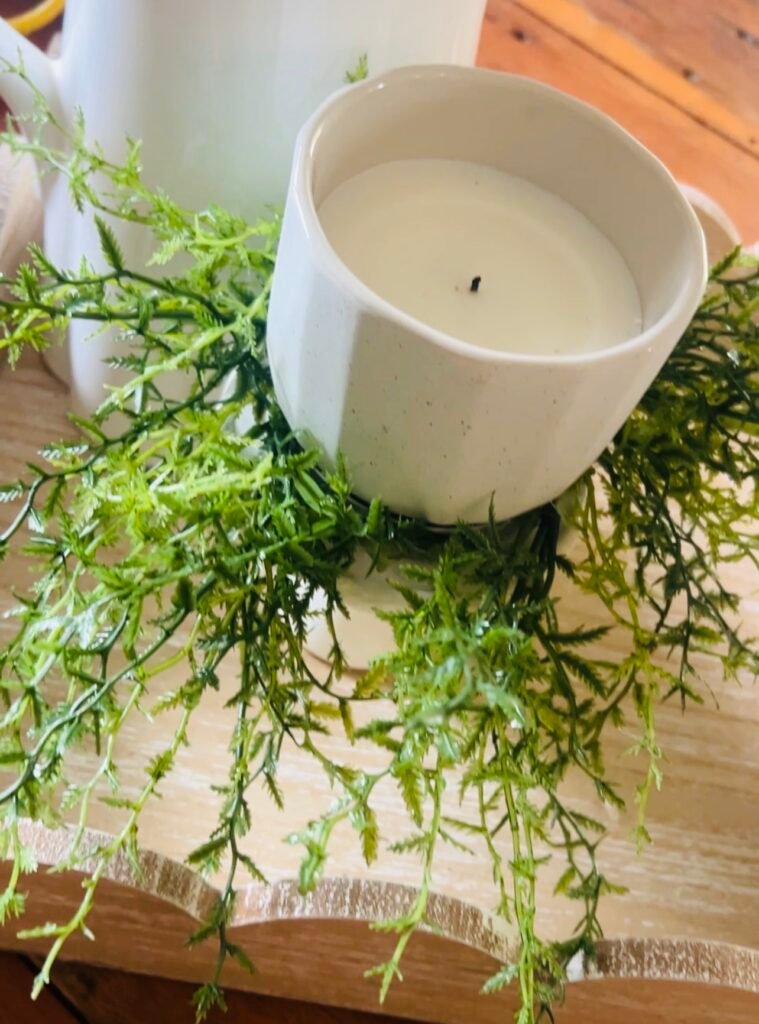 canning ring with greenery added and candle sitting inside